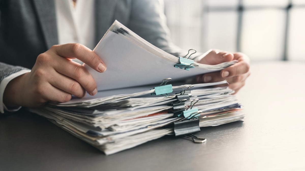 Business owner reviewing company tax paperwork and financial files