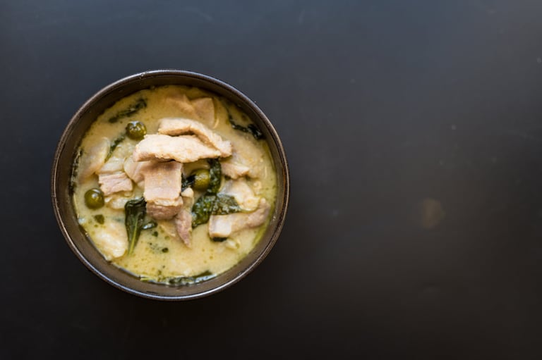 Traditional Thai green curry in an elegant setting
