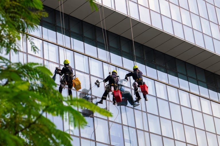 Team of window cleaners working on a high-rise exterior
