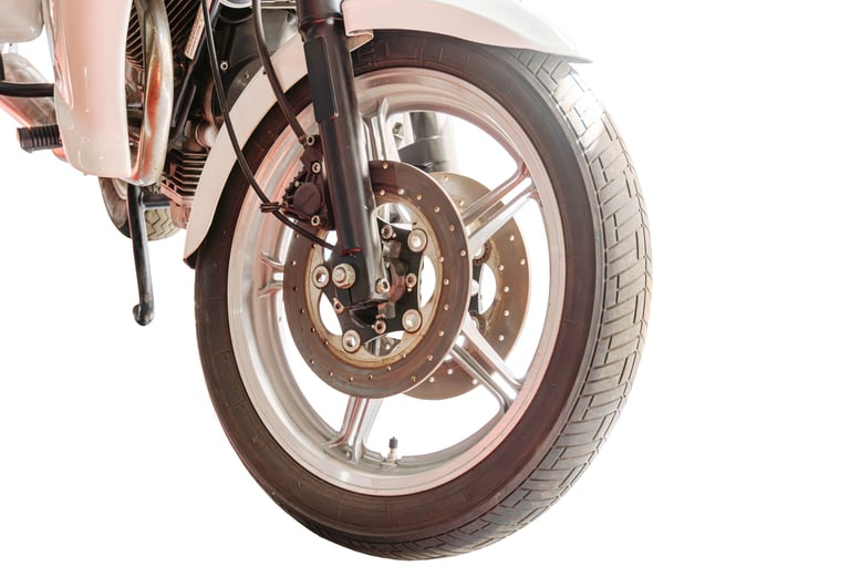Motorcycle wheel detail work at Arko Detailing Pretoria East — front rim, brake disc, and fork cleaned to showroom standard