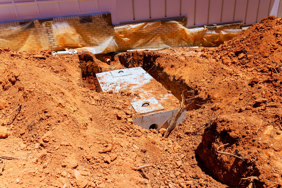 Concrete septic tanks being installed in a residential area
