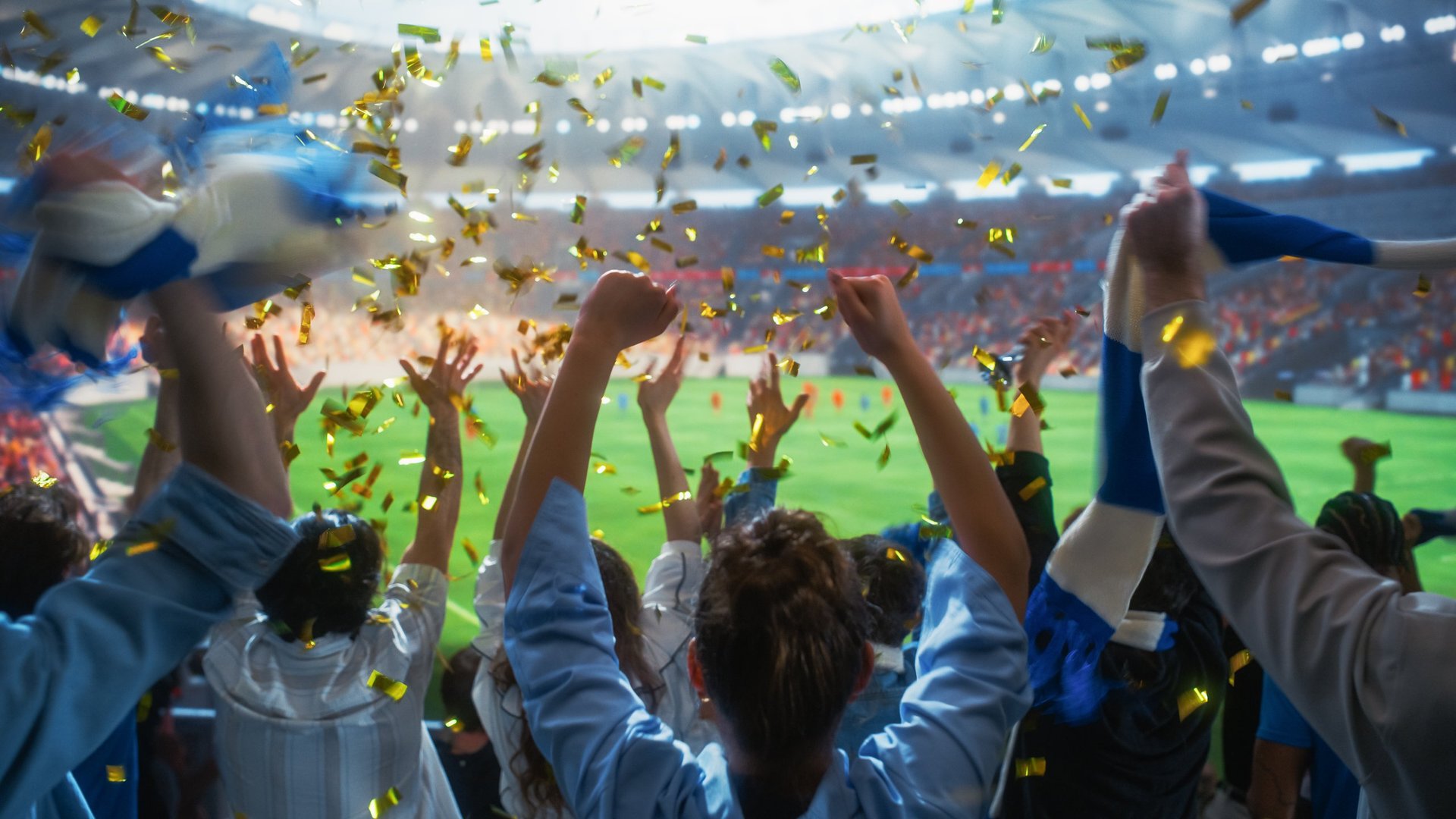 Excited sports fans celebrating with golden confetti falling in an Arizona arena