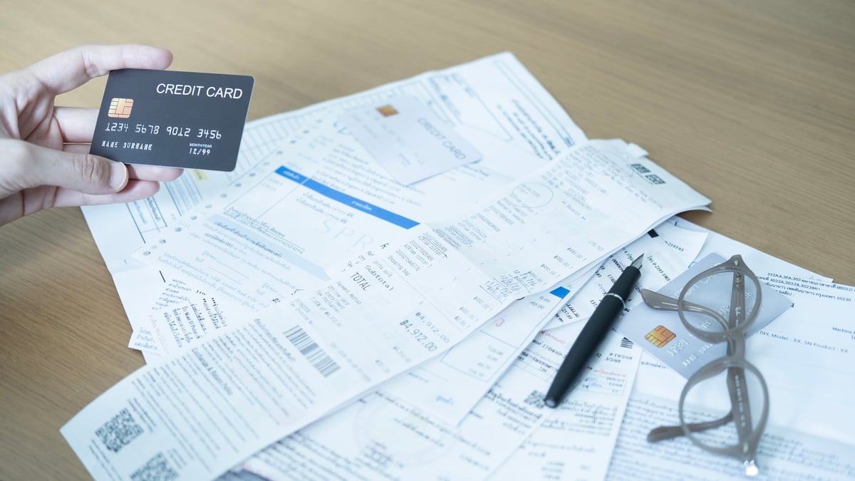 Credit card statements and household bills being reviewed for consolidation