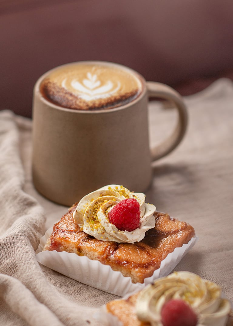 Artisanal almond tart with whipped cream and raspberry