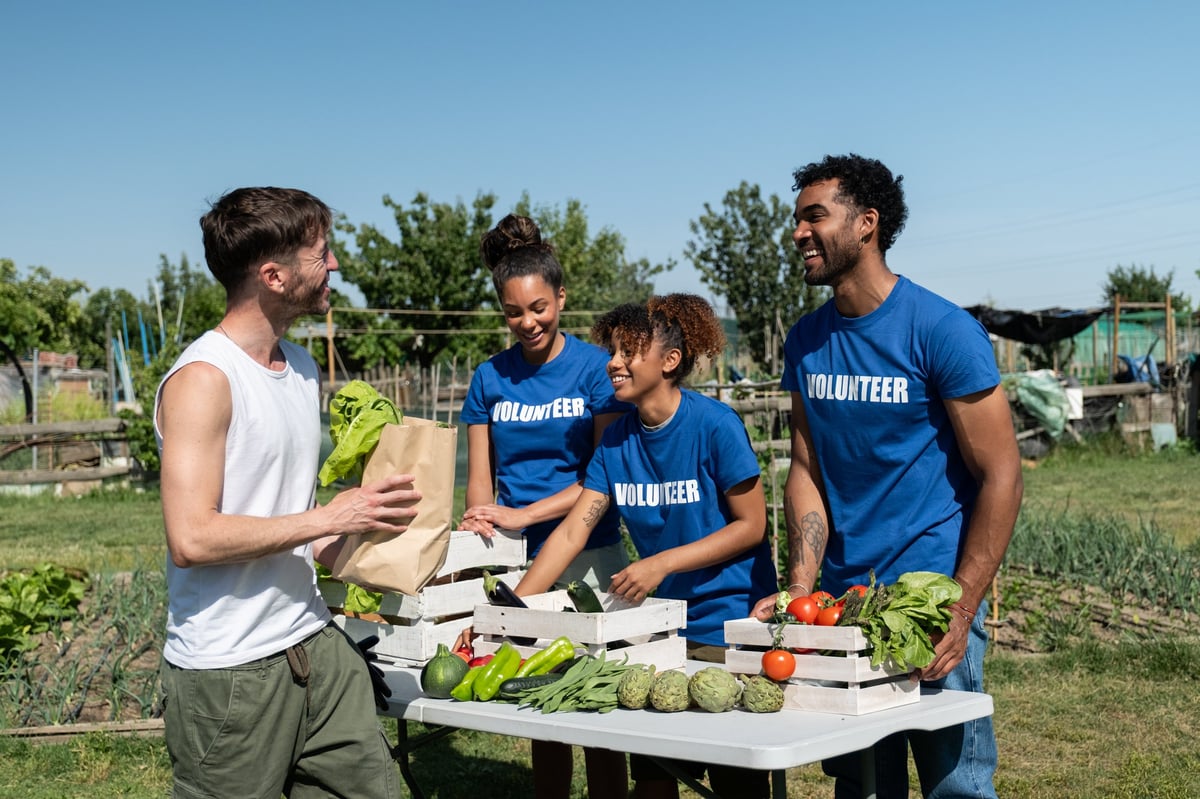 Volunteers distributing fresh produce in a community garden