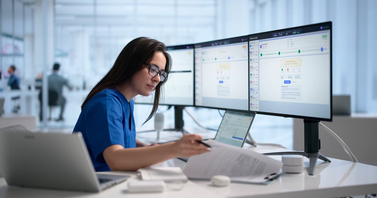 Healthcare professional reviewing patient care coordination on laptop