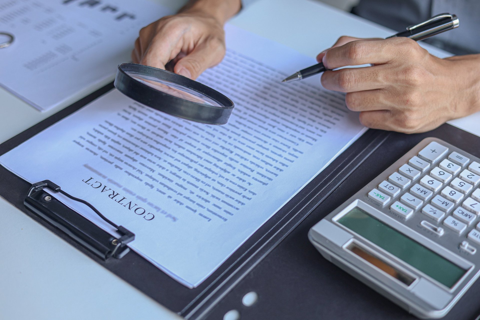 Business professional reviewing legal document and contract for asset recovery