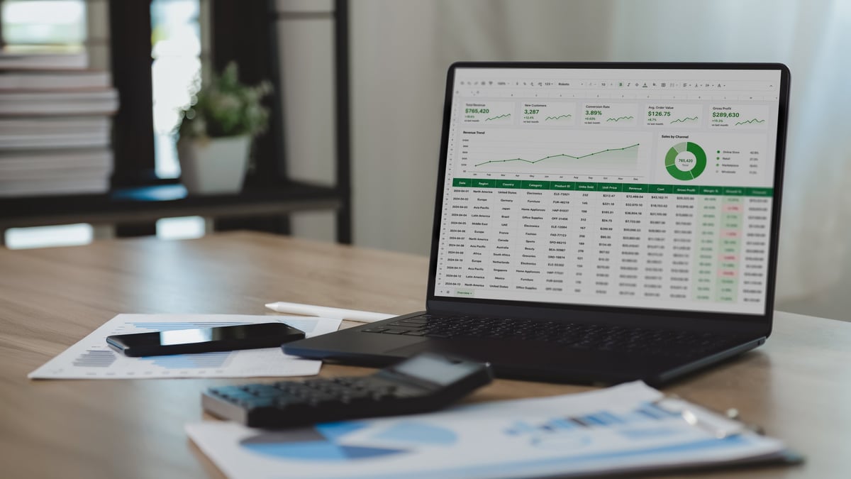 Business analytics dashboard on a laptop showing charts and reports