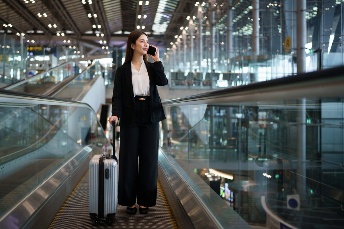 Business traveler using a mobile app while transiting through an airport