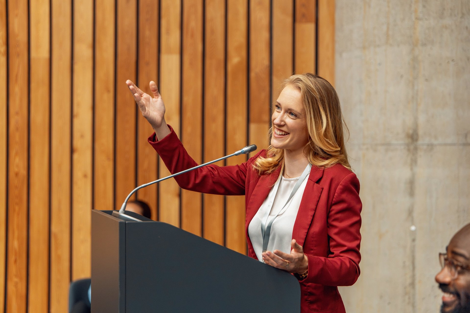 Speaker engaging a conference audience from the podium