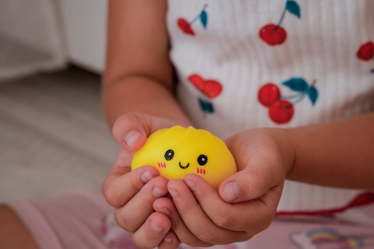 A child holding a soft squishy toy