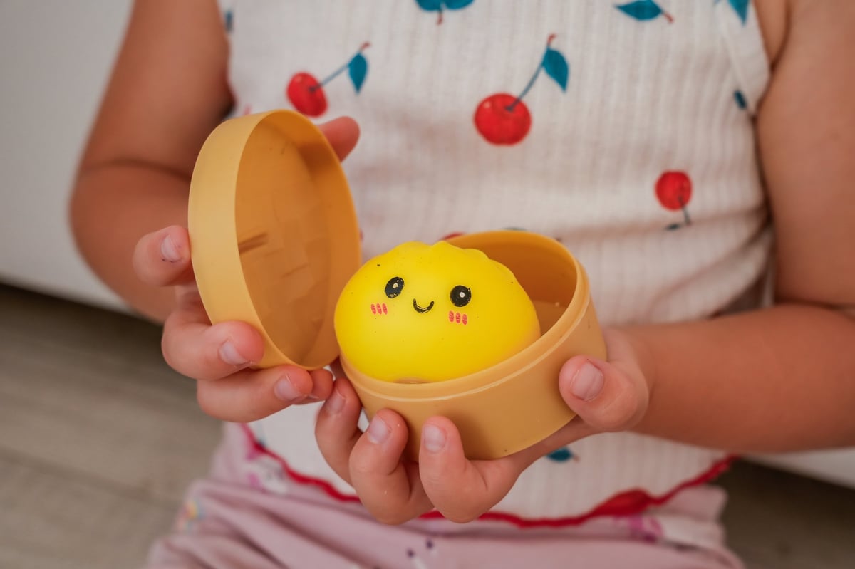 Hands holding a steamer of squishies