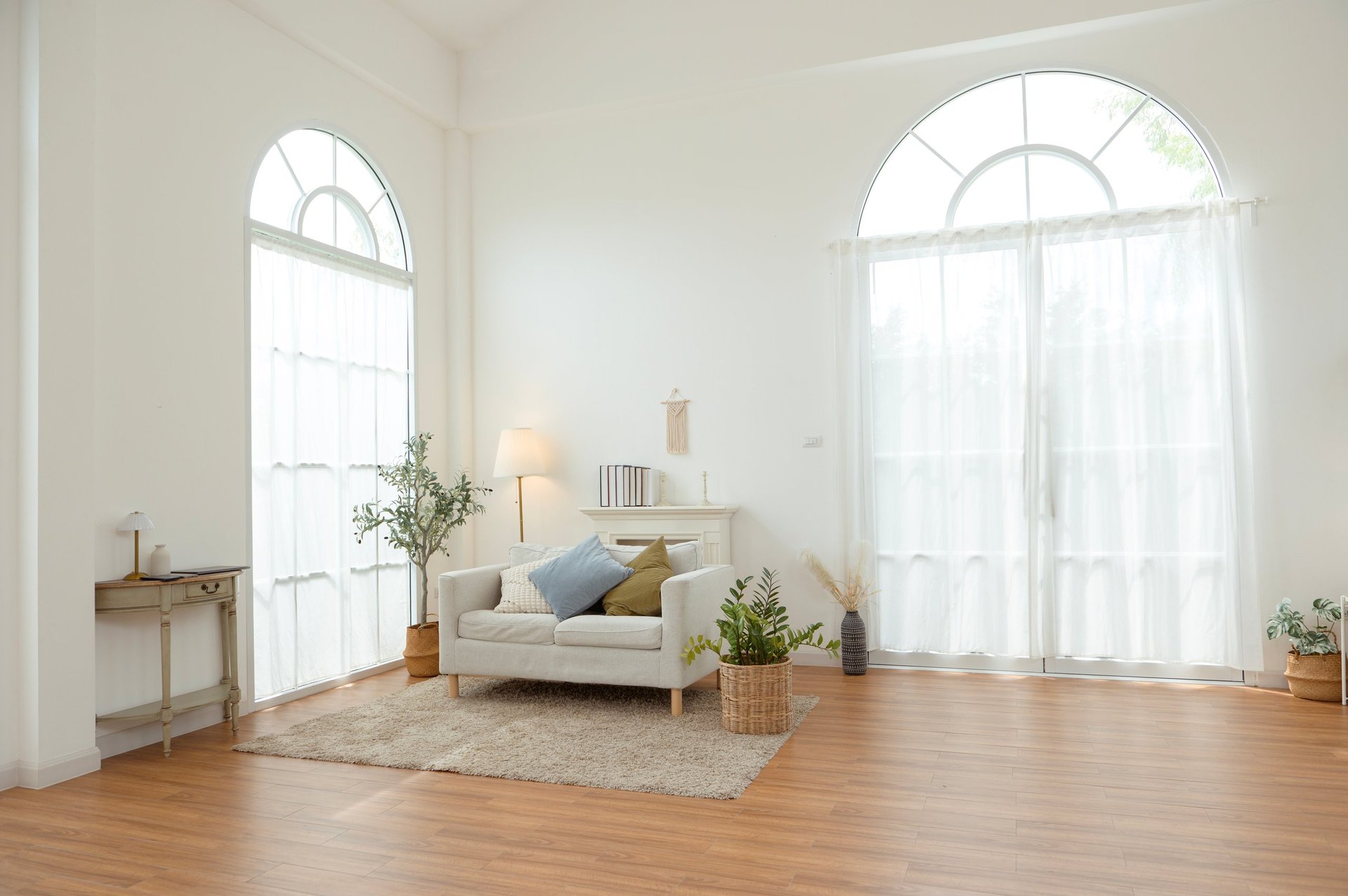 Cozy living room with large windows and soft decor, freshly cleaned and bright