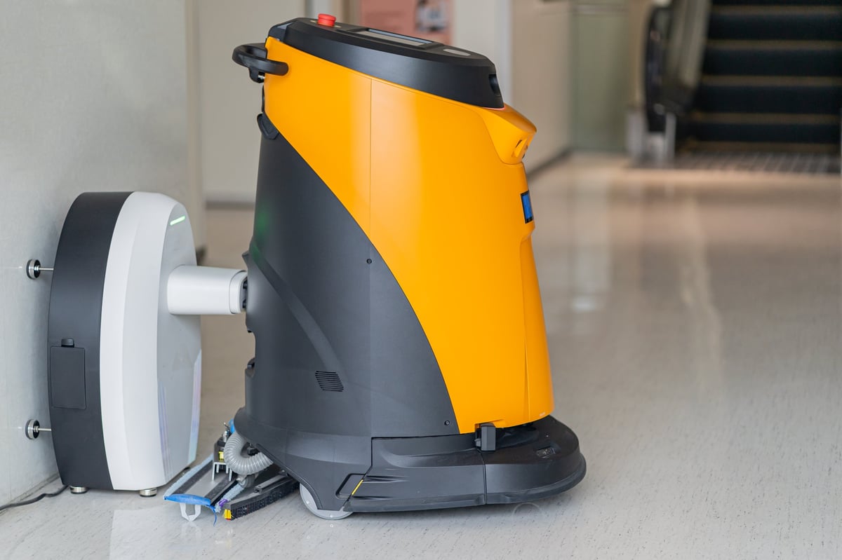Automatic cleaning robot mopping the floor of a modern public space