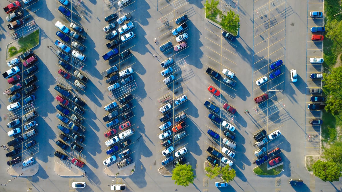 Structured parking stalls framing commuter cars in a suburban commercial precinct