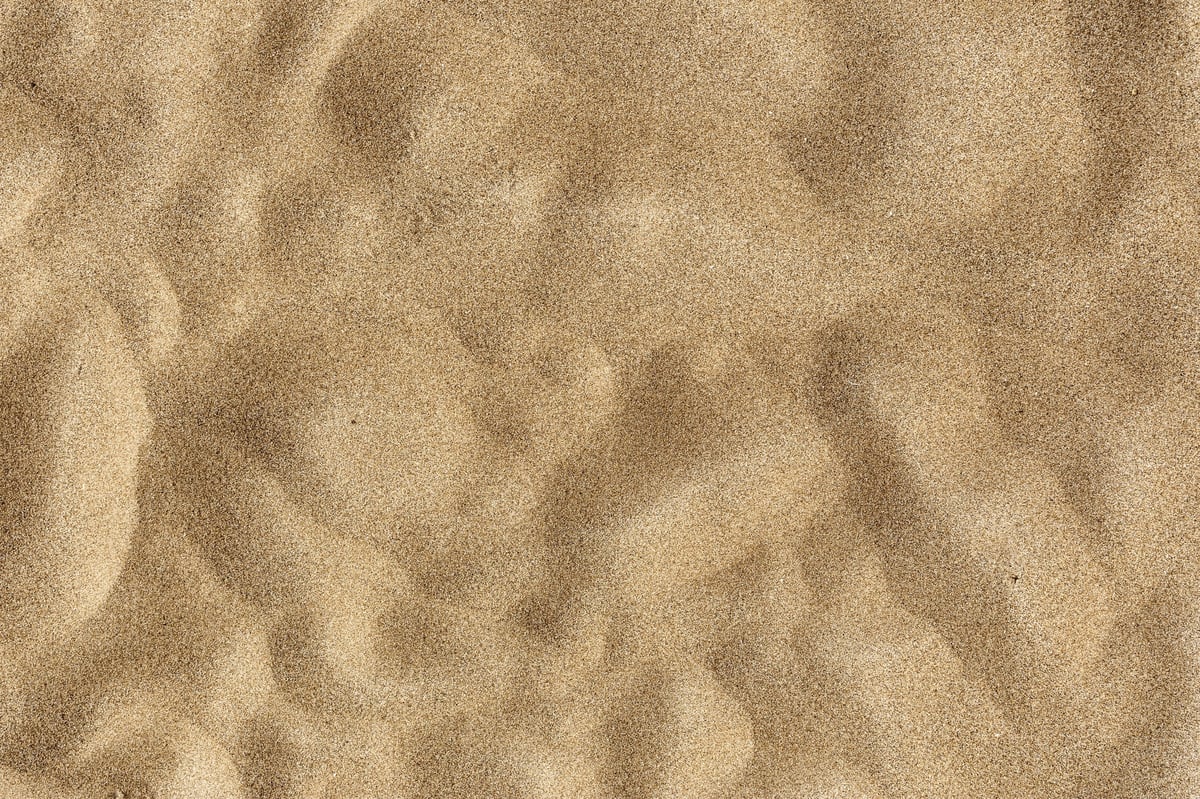 Smooth sand texture representing grounding wellness