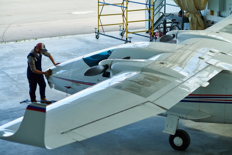 Mechanic wiping aircraft after finished work