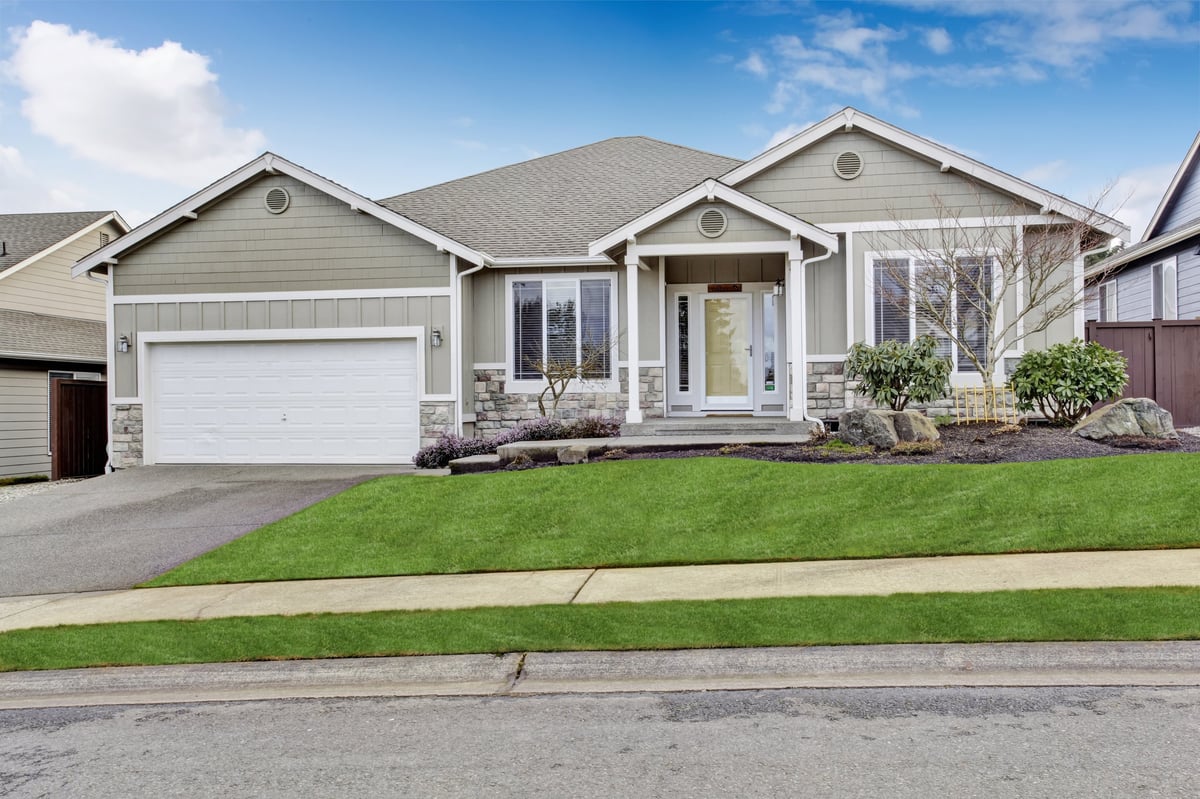 House exterior with entrance porch, walkway, and garage