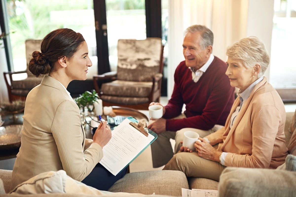 Financial consultant advising a senior couple on long-term care planning