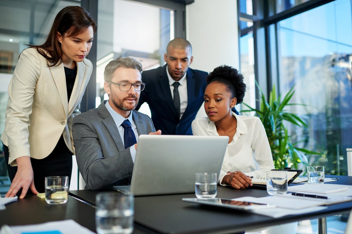 Professional business team collaborating with digital tools in modern office environment