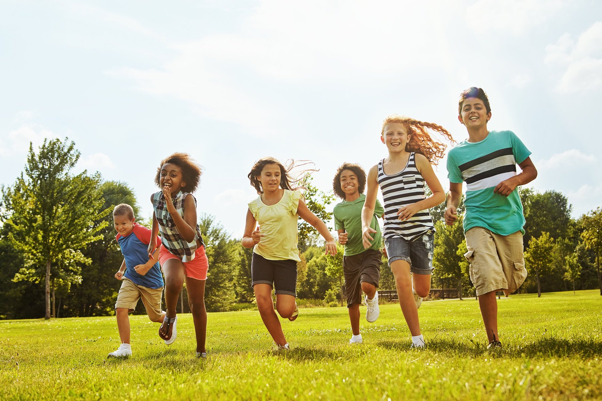 Young students playing and moving together outdoors