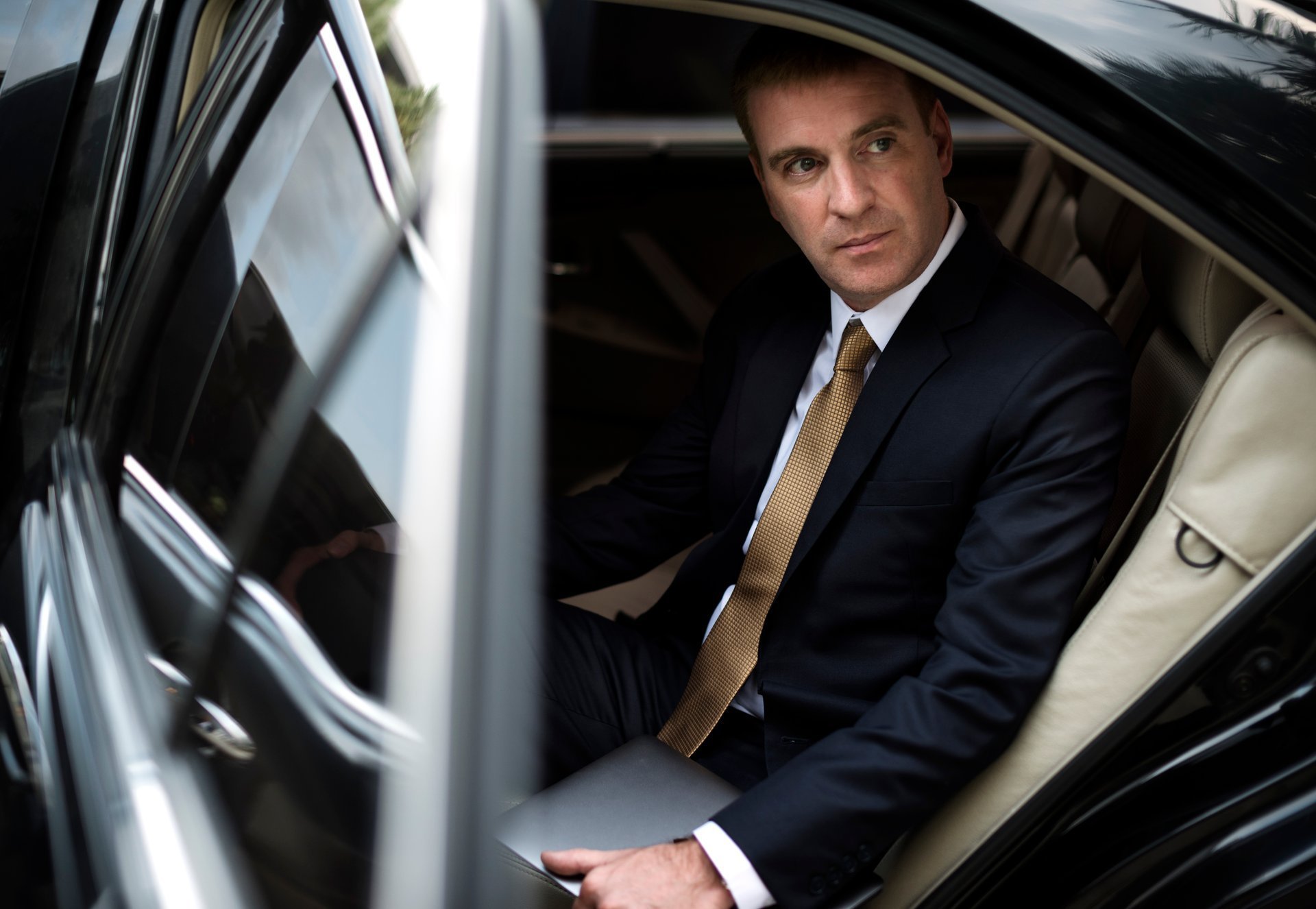 Businessman luxury taxi transport service — professional chauffeur transfer