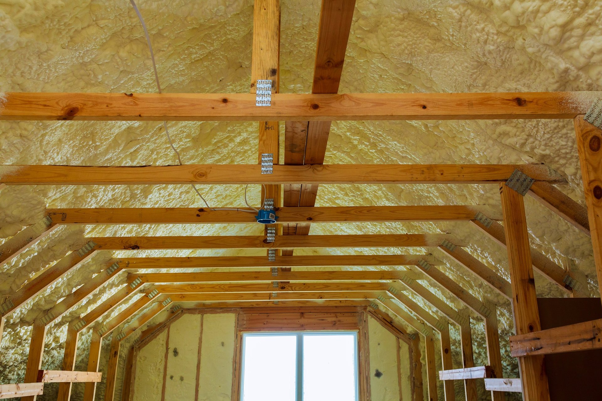 Thermal and hidro insulation with spray foam at house construction site