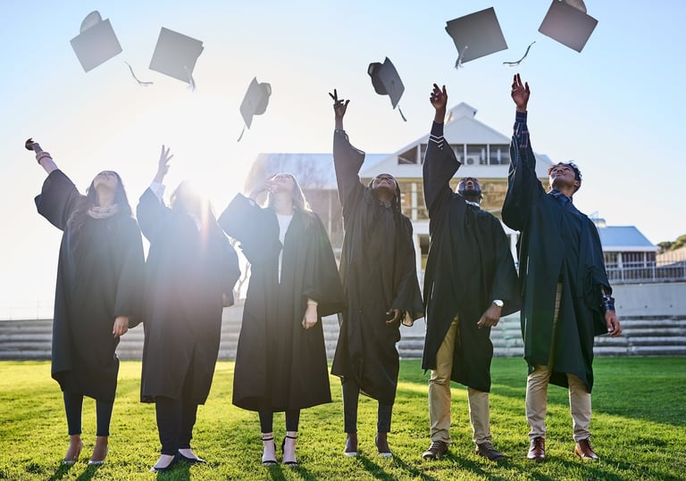 Lighthouse Private Christian Academy graduates celebrating by throwing their caps into the air on graduation day