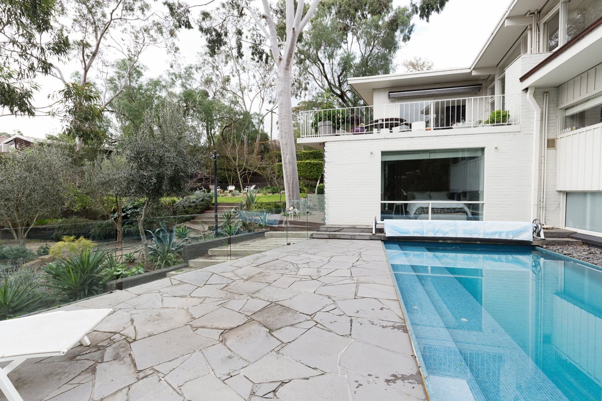 Elegant natural stone patio with seating area — Capital Estate Exteriors Ottawa hardscaping