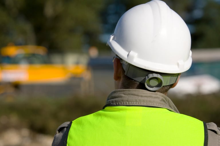 A construction worker on site and dressed in safety clothing