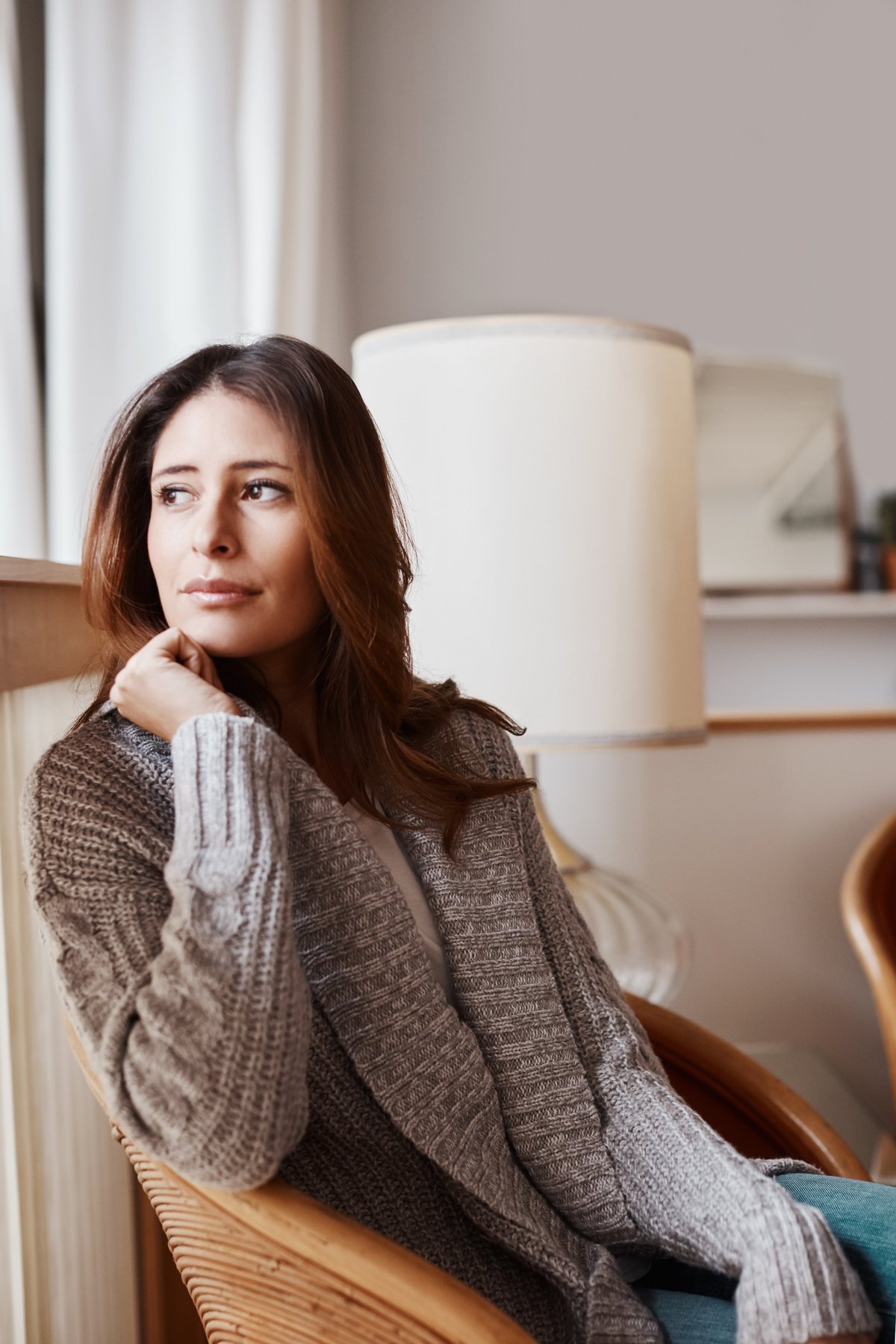 A young woman relaxing at home in a quiet, calm moment, understanding her own body and cycle