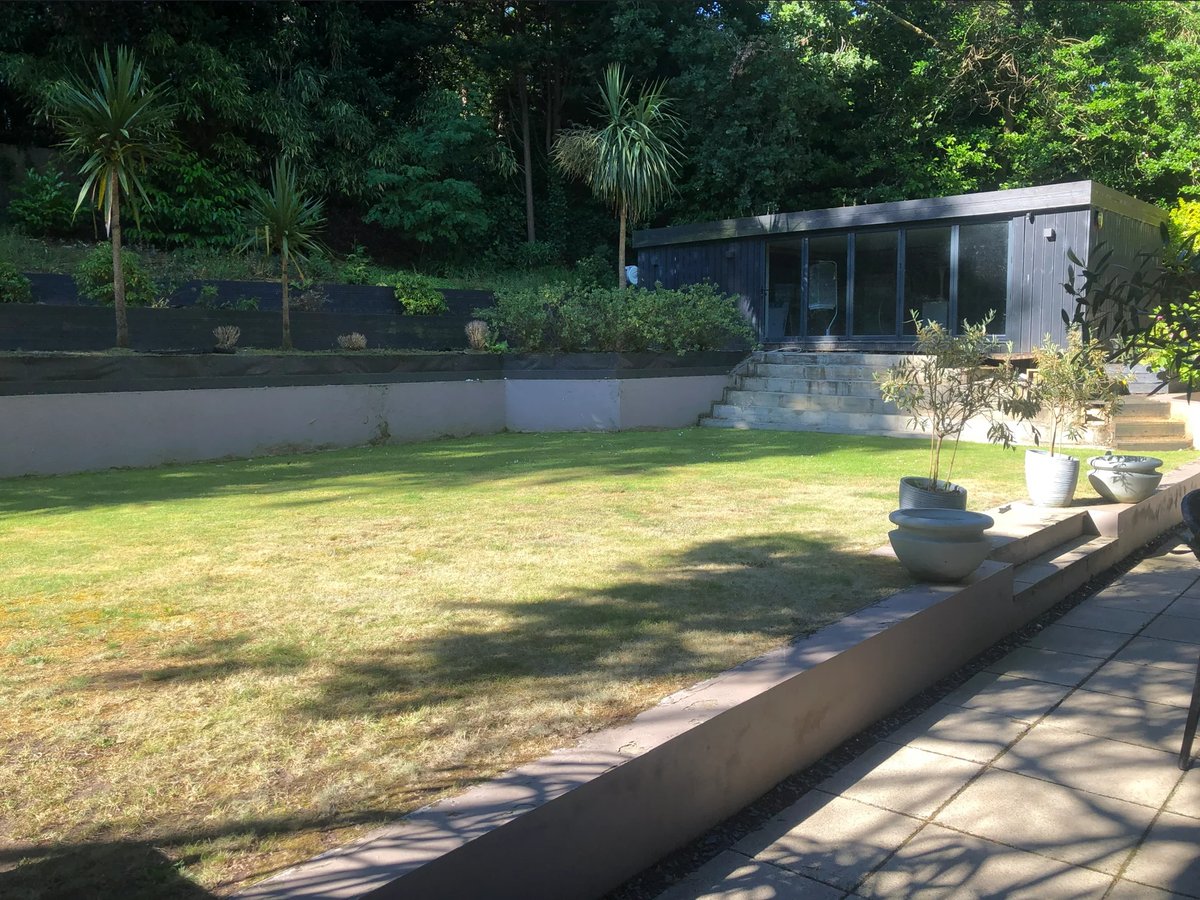 Before: original garden with single cabin, lawn, and small patio