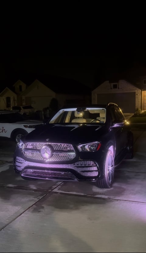 KJAJ Details finished detail — black luxury sedan with purple accent lighting at night