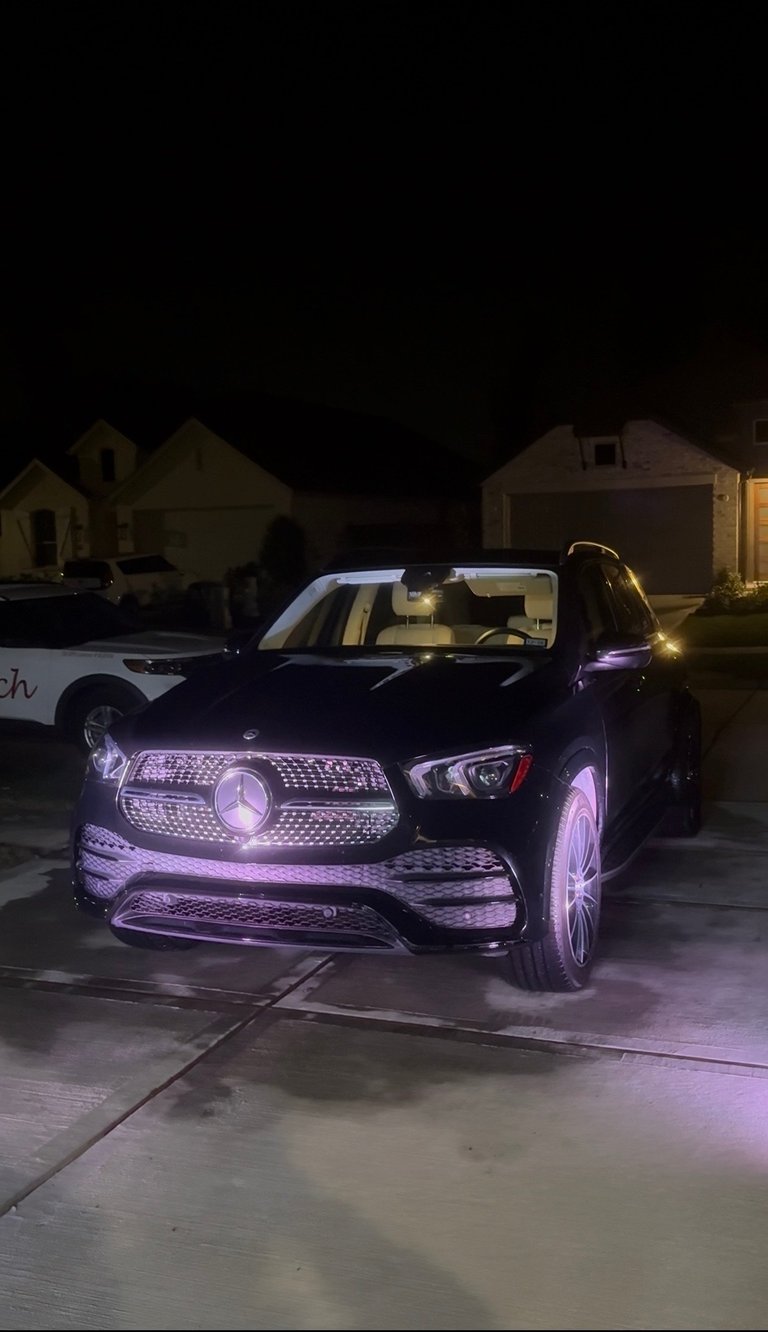 Black luxury sedan with purple ambient accent lighting at night — KJAJ Details finished detail