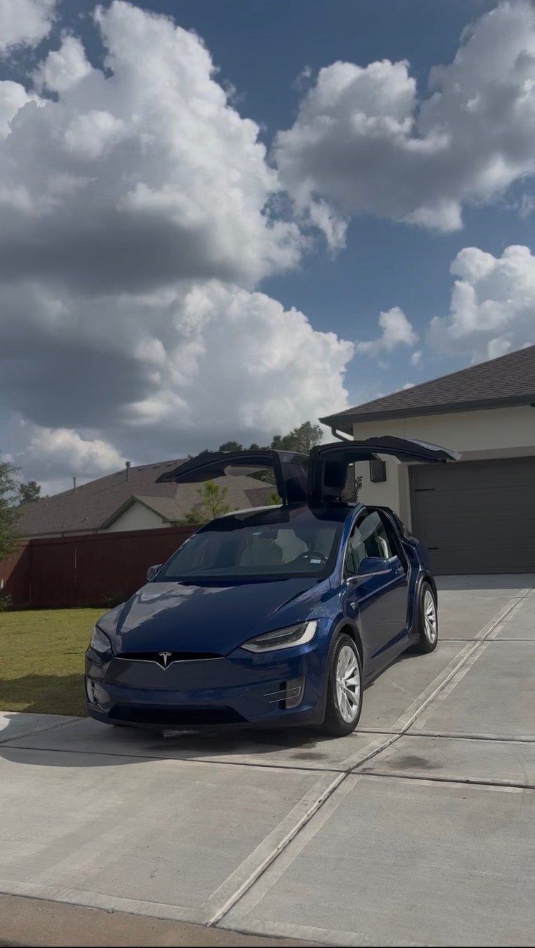 Deep blue Tesla Model X with falcon wing doors open in a residential driveway — KJAJ Details finished detail