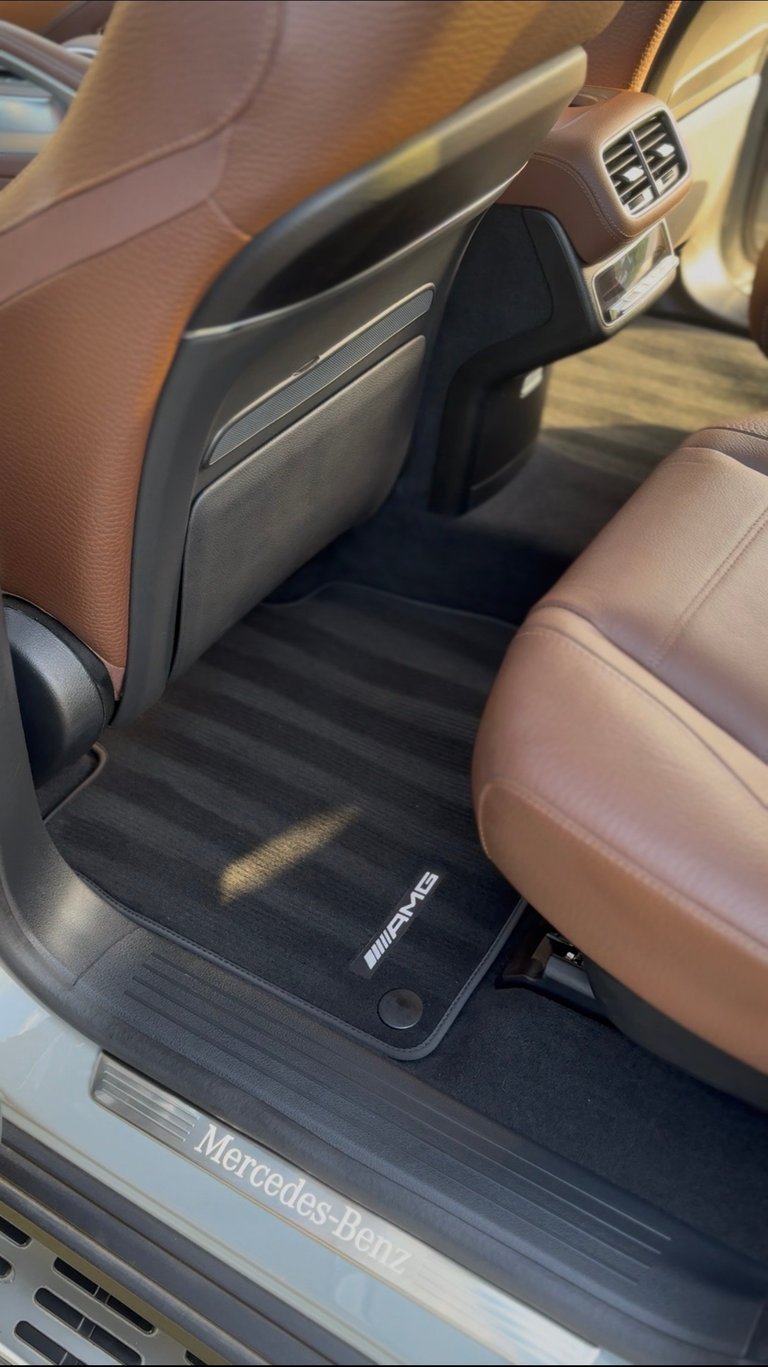 Mercedes-Benz driver-side cabin with brown leather seats, AMG floor mats, and dashboard air vents — KJAJ Details interior detail