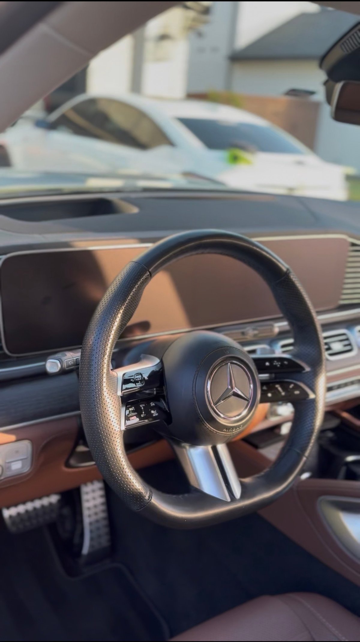 Mercedes-Benz luxury interior with brown leather seats, AMG-branded black floor mats, and chrome air vents — KJAJ Details interior detail