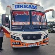 Orange and white commercial truck with DREAM text on cab, parked on street