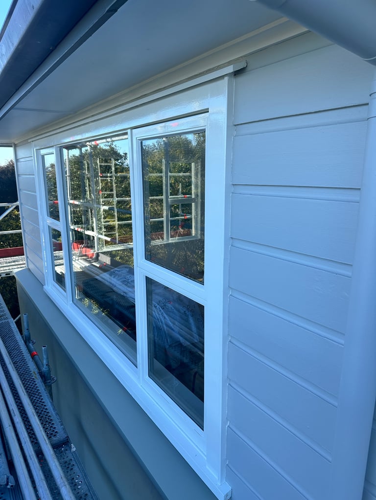 New white joinery units and freshly painted horizontal weatherboards on the completed Parnell home exterior