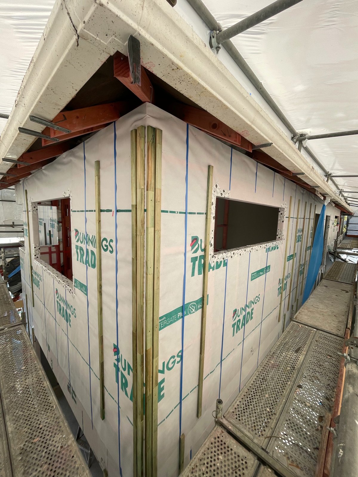 House wrapped in breathable building paper as part of the cavity system during the Hauraki reclad