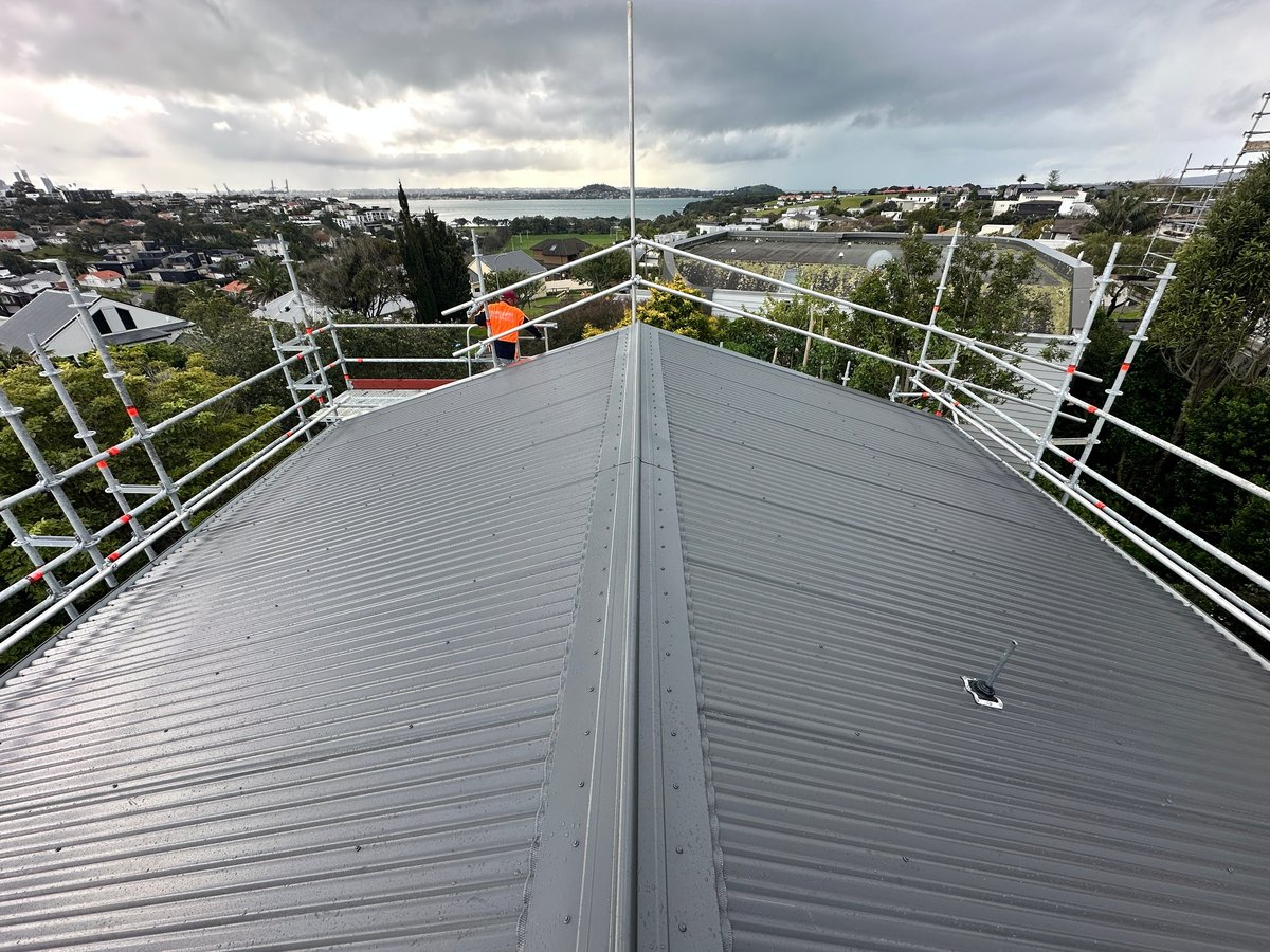 New corrugated metal roof completed on the Parnell home with the harbour and city beyond
