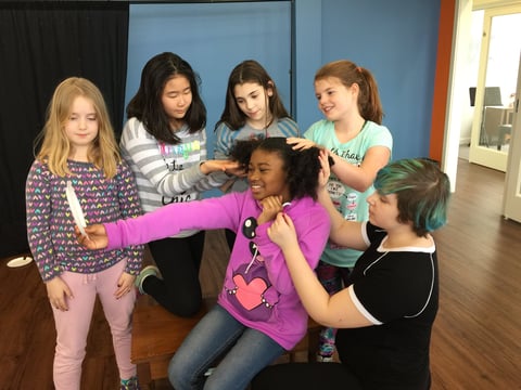 Group of children and young teens posing together indoors