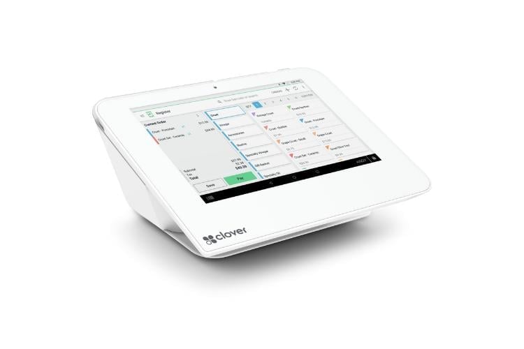 White touchscreen tablet displaying a calendar or scheduling application interface with colored event blocks