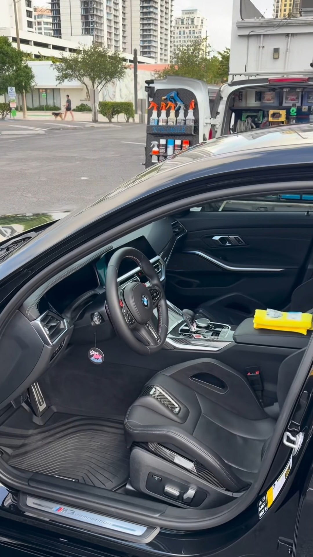 BMW with open door showcasing premium dark interior