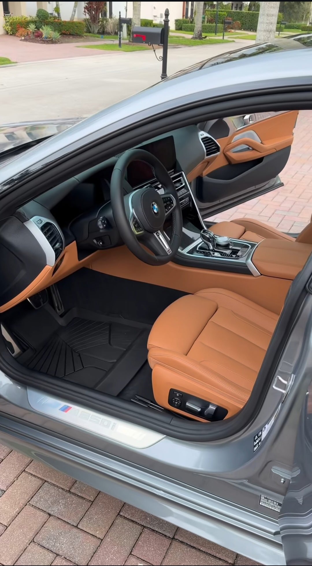 BMW sports car with tan leather seats and orange door panels