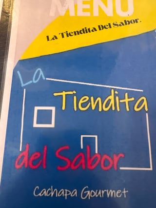 Menu cover for La Tiendita Del Sabor, a cachapa gourmet restaurant, featuring blue and yellow design with hand-drawn elements