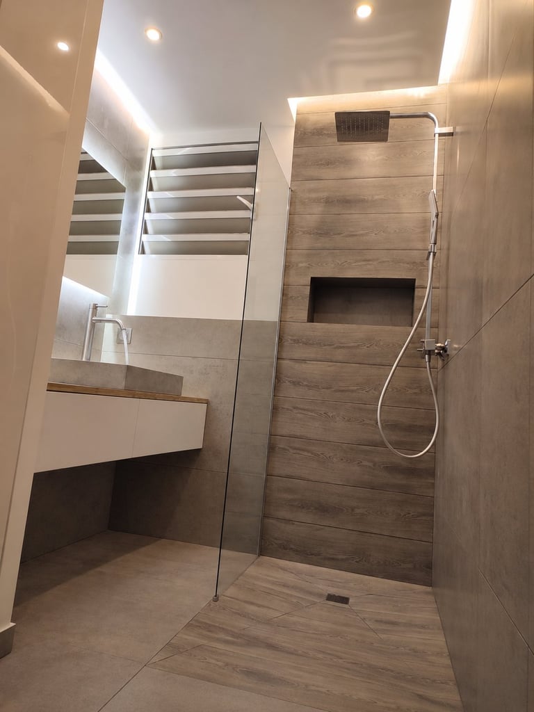 Modern bathroom with walk-in shower featuring wood-look tile walls, glass enclosure, white sink vanity, and recessed ceiling lights