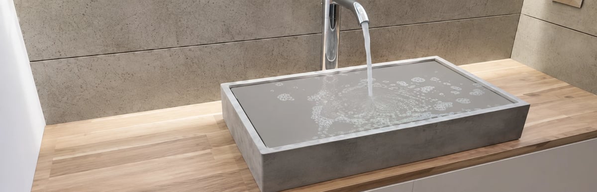 Modern rectangular sink with white faucet on wooden vanity in contemporary bathroom