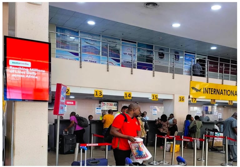 Airport check-in counter with passengers in line, digital display boards, and numbered service windows