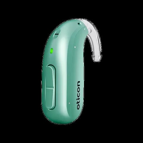 Mint green hearing aid with white ear hook and green indicator light on black background
